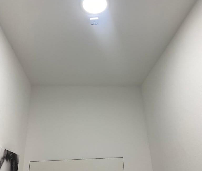 a hallway motion sensors next to lamp on the ceiling